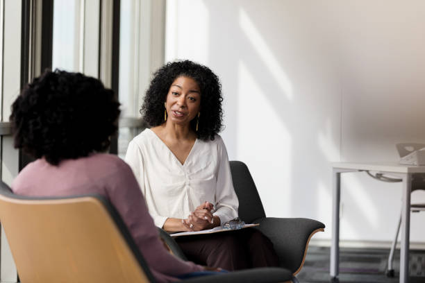 istock Female counselor talks with female patient 1206311502