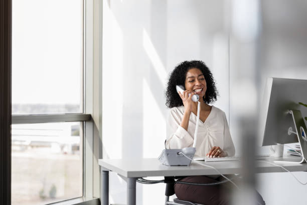 istock Businesswoman uses phone in her office 1206311564