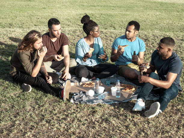 istock Relaxed friends having picnic in park 1206315669