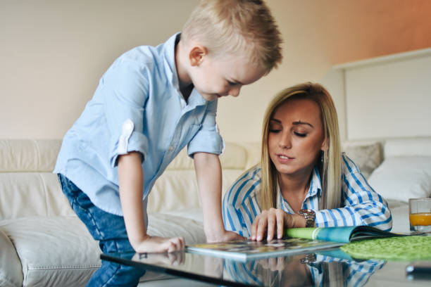 istock Mother Sitting With Son Reading Story Indoors 1206320315