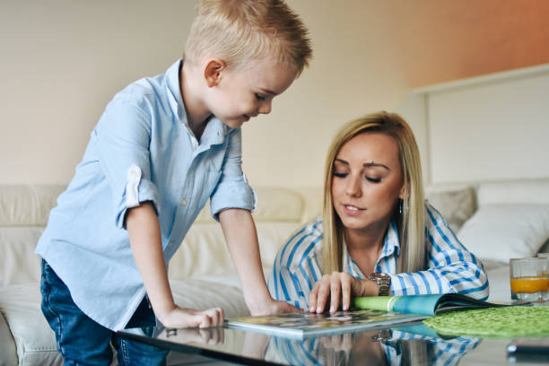 istock Mother Sitting With Son Reading Story Indoors 1206320318