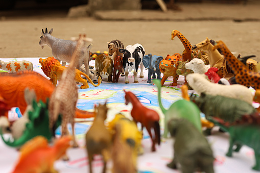 A composition of toy animals around Planet Earth as a symbol of protection, care and love towards our Planet