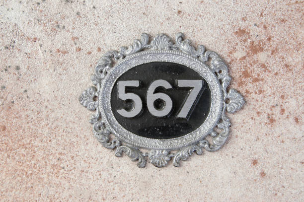 istock Antique door number on concrete background 1206324332