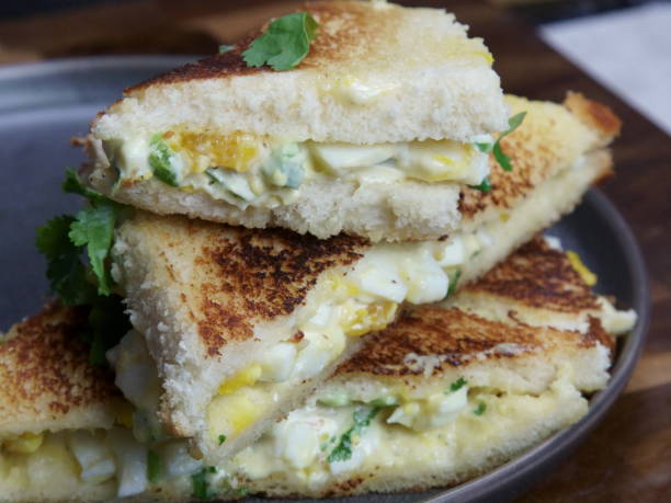 istock A stack of Bread and egg salad with mayonaise sandwich on a plate with copy space. 1206324688