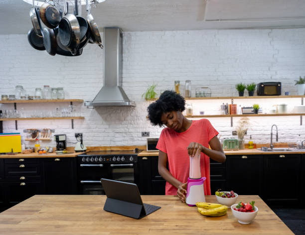 istock Woman at home making a smoothie for breakfast 1206327574