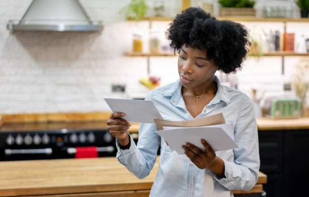 istock Black woman at home checking the mail 1206327577