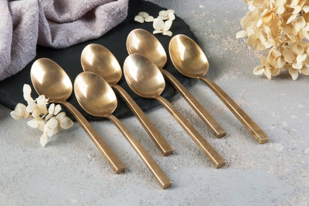 istock Old bronze tea spoons on concrete 1206330243