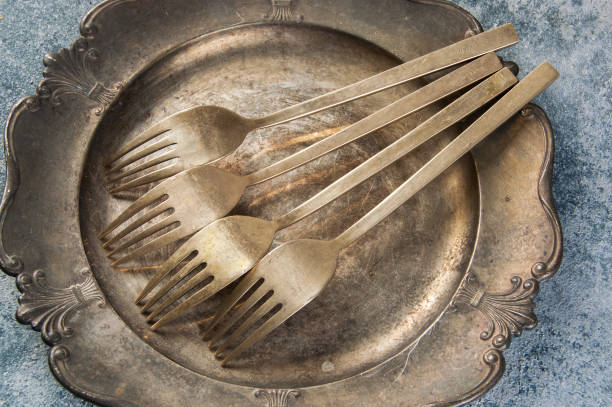 istock Old bronze forks on vintage dish 1206331954