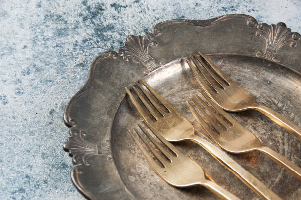 istock Old bronze forks on vintage dish 1206332604