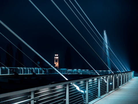 Lighted footbridge between France and Germany at night. Strasbou in France, Grand Est, Strasbourg