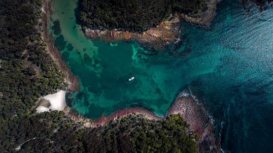 Birds eye drone shot of ocean to inlet in Jervis bay national park