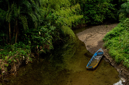 blue canoe on a clean river in Bajo Sabaletas, Valle del Cauca, Colombia