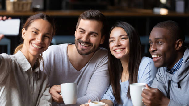 istock Happy diverse friends make selfie in cafe together 1206334670