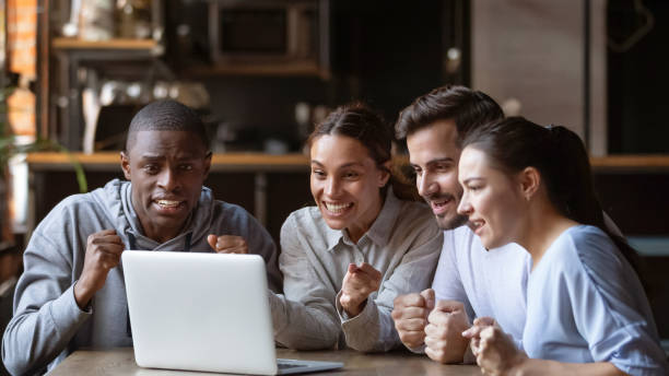 istock Excited diverse friends cheering watching match on laptop online 1206334676