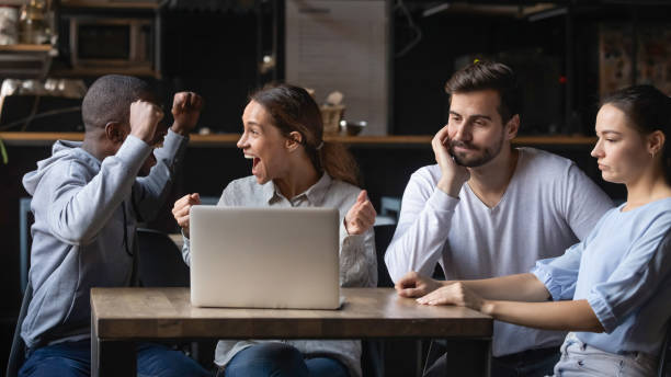 istock Multiracial friends support different teams watching game in bar 1206334693