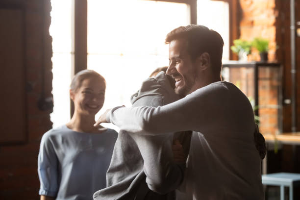 istock Smiling diverse friends hug greeting meeting in bar 1206334704