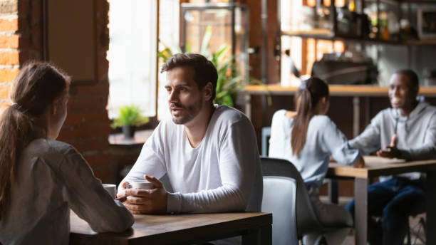 istock Diverse people sitting in cafe enjoying hot coffee 1206334707
