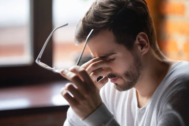 istock Exhausted male massage eyes suffering from headache 1206334727