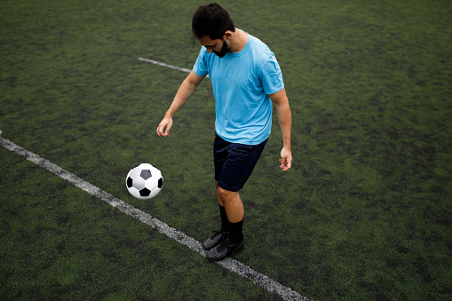 Young adult playing soccer.