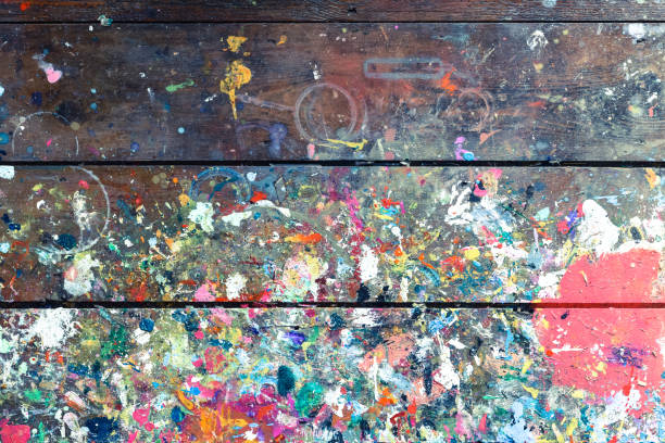 мастерская художников или скамейка студии, покрытая забрызганной краской, построенной в аутентичной текстуре на окрашенной поверхности - craft paint стоковые фото и изображения