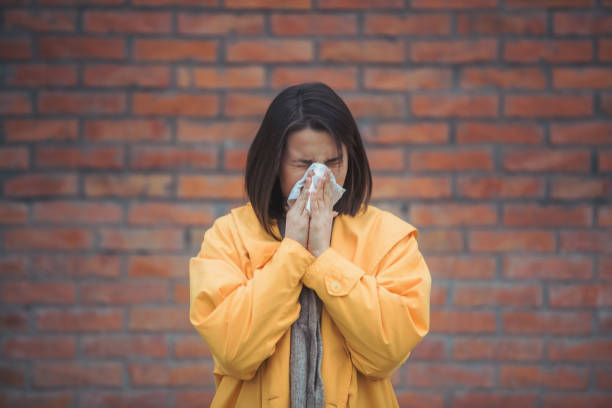 istock Sick young woman blowing her nose 1206335690