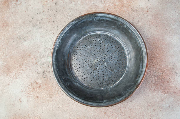 istock Antique copper sieve on concrete background. 1206337732