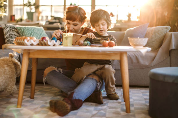 istock Mom Teaching Son How to Color Eggs 1206338483