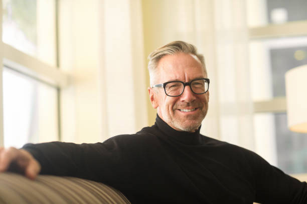 istock Portarit of a handsome older man sitting on a sofa 1206343998