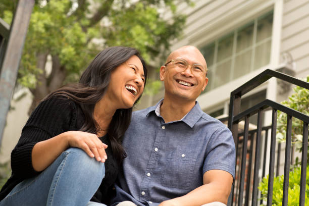 istock Happy Asian couple smiling and hugging outside. 1206344130