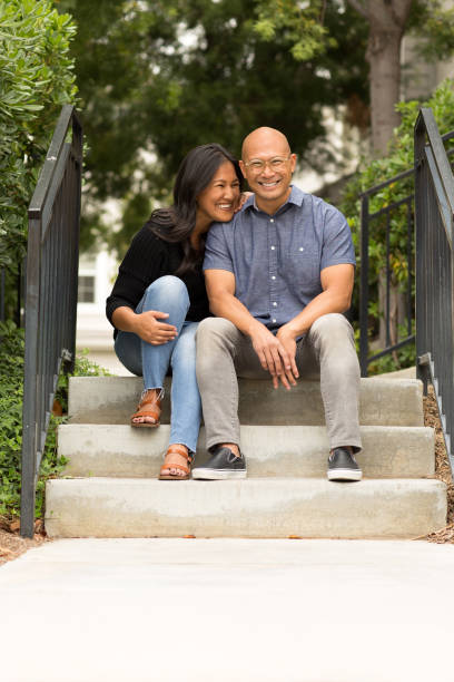 istock Happy Asian couple smiling and hugging outside. 1206344343
