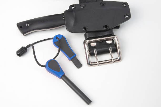 istock knife for tourism and hunting with a plastic case on a black leather belt on a white background. ignition steel for striking fire 1206347967