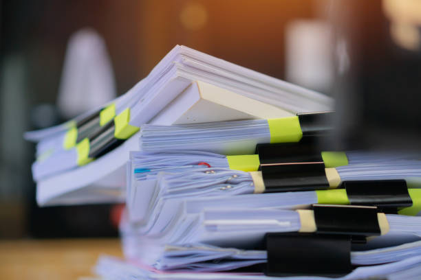 istock Stack unfinished documents reports files, pile business paper with overwork paperwork on teacher desk office at university, messy sheet book assessment legal folder at workplace. Archive of document 1206350517