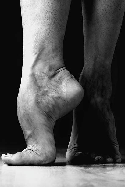 Contemporary dancer feet Closeup to contemporary dancer feet, while she is performing,black and white studio shot ballet dancer feet stock pictures, royalty-free photos & images