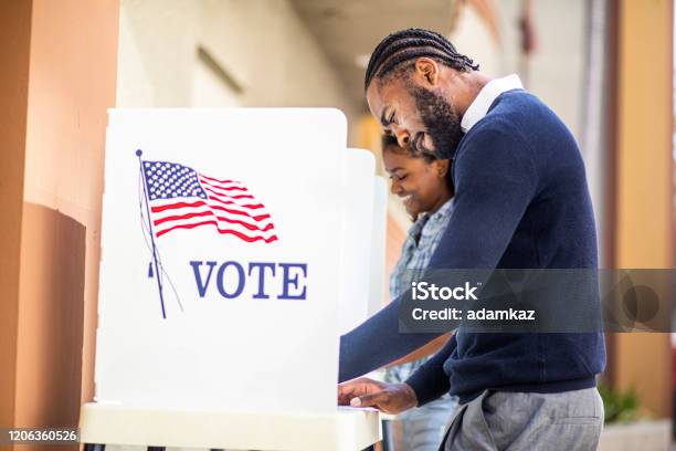 Millenial Black Man And Woman Voting In Election Stock Photo - Download Image Now - Voting, African-American Ethnicity, Black Color
