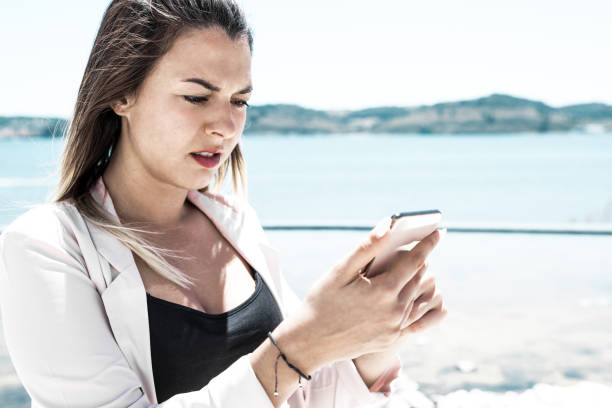 istock Frowning confused user holding smartphone and staring at screen 1206363808