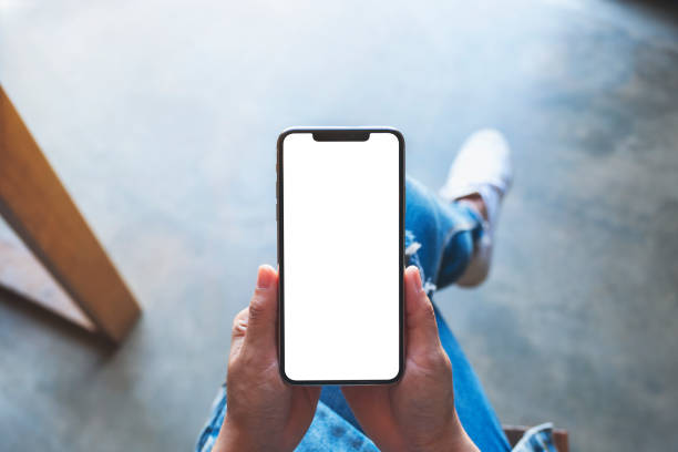 istock a woman holding black mobile phone with blank white screen while sitting in cafe 1206363838