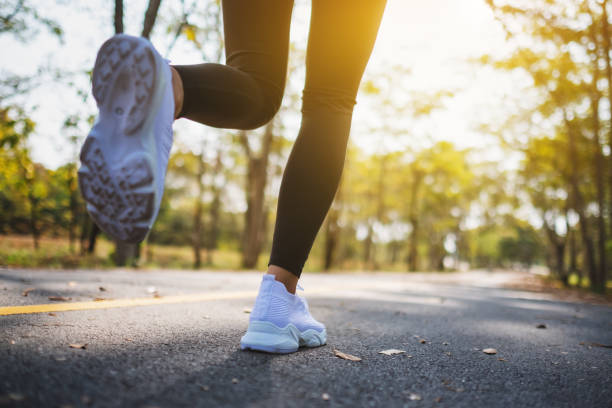 istock a woman's legs while jogging in city park in the morning 1206363879