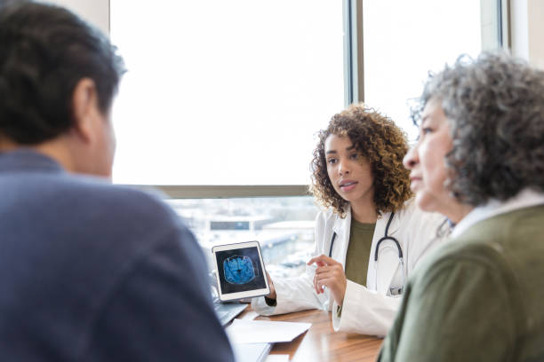 istock Female neurologist discusses brain scan with patient 1206365627