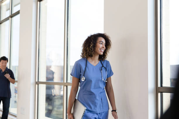 istock Confident nurse walking in hospital corridor 1206365672