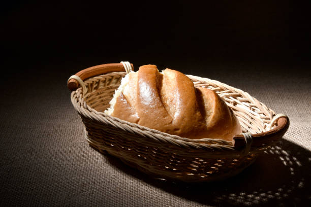 istock Half a loaf of white bread in a wicker basket 1206366513