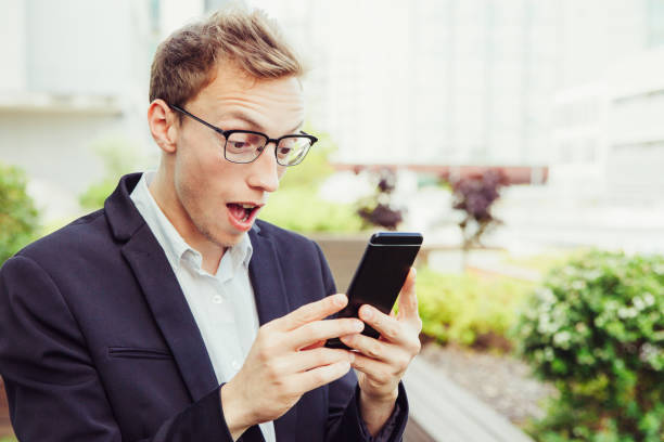 istock Excited office employee with cellphone getting shocking news 1206367672