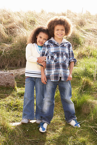 istock Boy And Girl Playing In Field Together 120637174