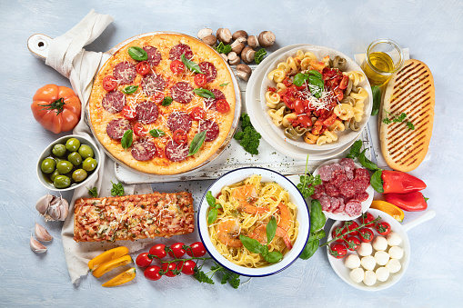 Traditional Italian foods  with pizza, pasta, olives, vegetables. Healthy mediterranean diet. Top view, flay lay