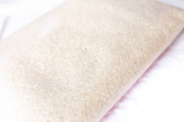 Jasmine rice in plastic clear bag on white background.