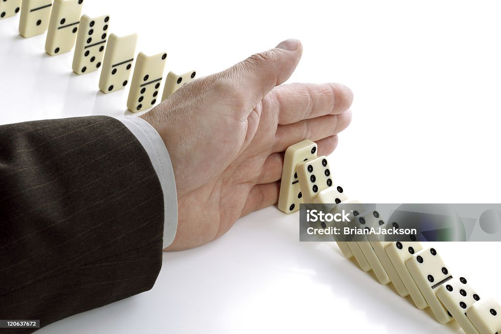 Solution Concept for solution to a problem by stopping the domino effect Activity Stock Photo