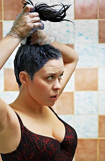 istock woman dyeing hairs 120637699