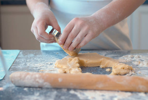 istock Girl making cookies with a cookie cutter 1206380153