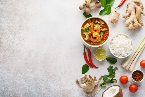 Tom Yum Goong or Tom Yam Kung and various ingredients for cooking. Background with copy space. Menu or recipe mockup.