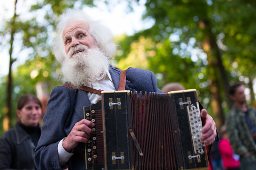 Old gray grandfather with accordion.Russian soul.