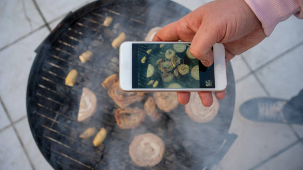 istock man taking a barbecue photo 1206384928
